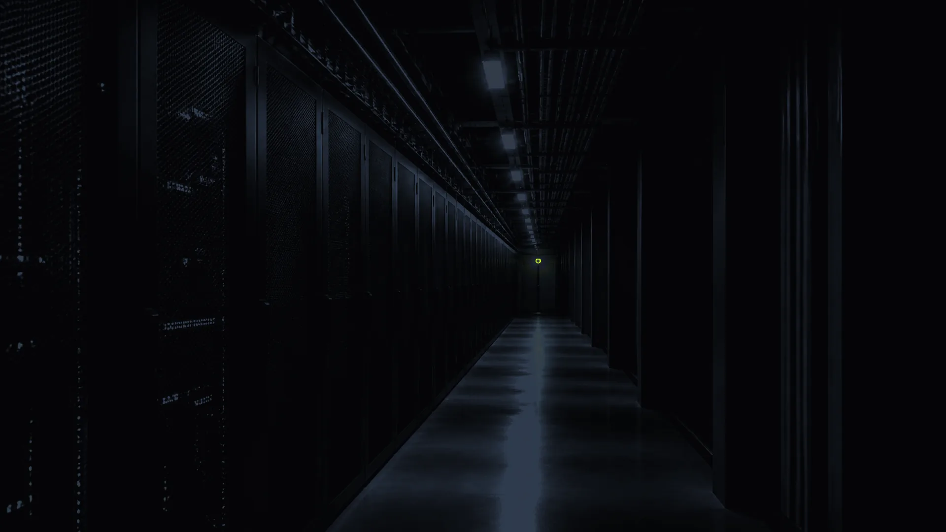 Dim infrastructure corridor with one yellow signal suggesting the operating system underneath.